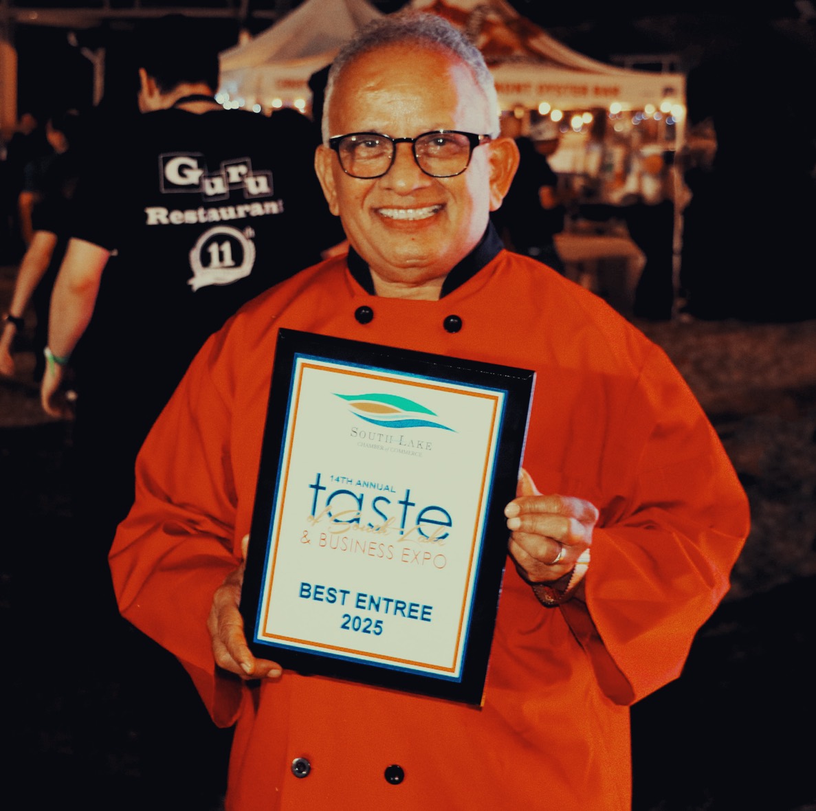 Uday Kadam holding an award from Business Expo 2025 for the best entree award